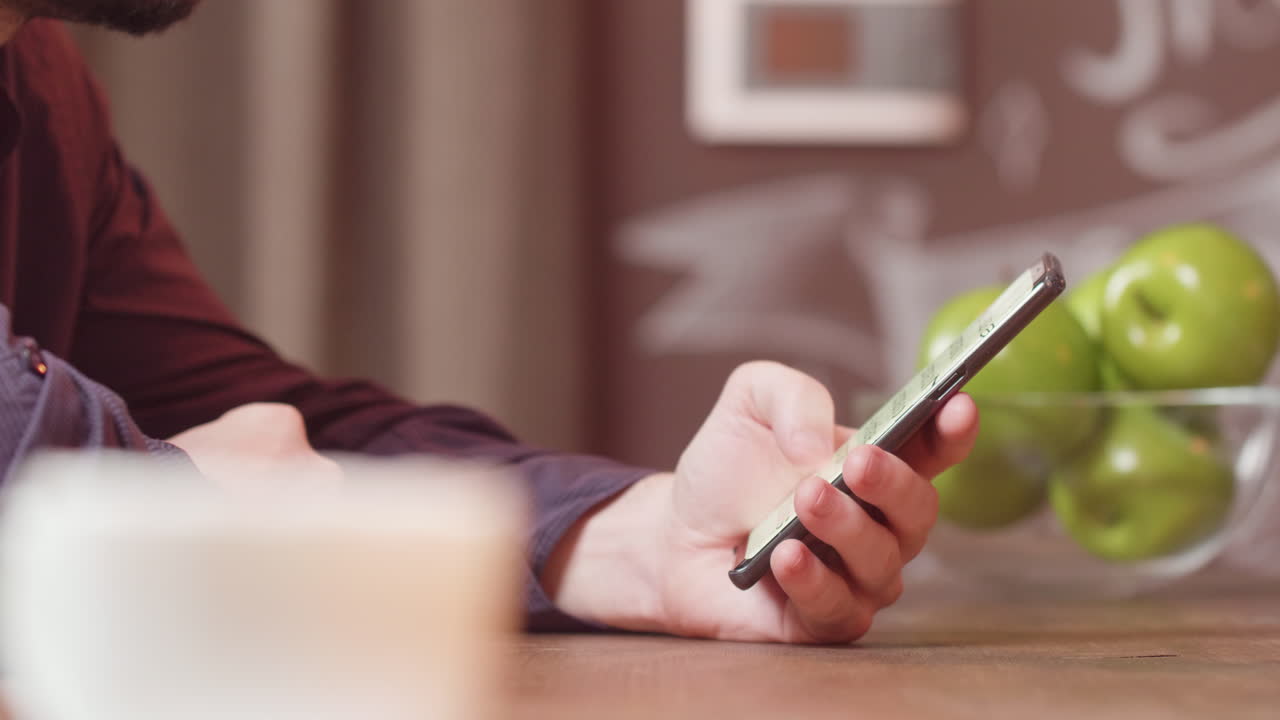 Person using a cellphone at a table
