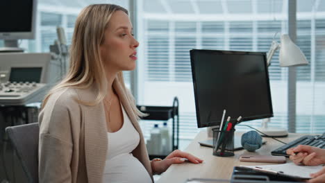 consulting doctor taking notes during medical examination. closeup pregnant