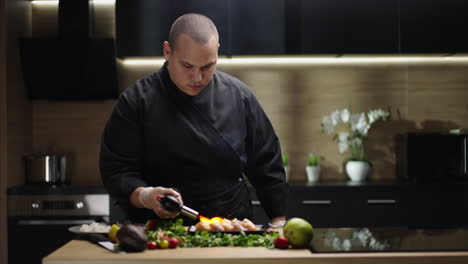 chef using a blow torch to prepare food in a modern kitchen