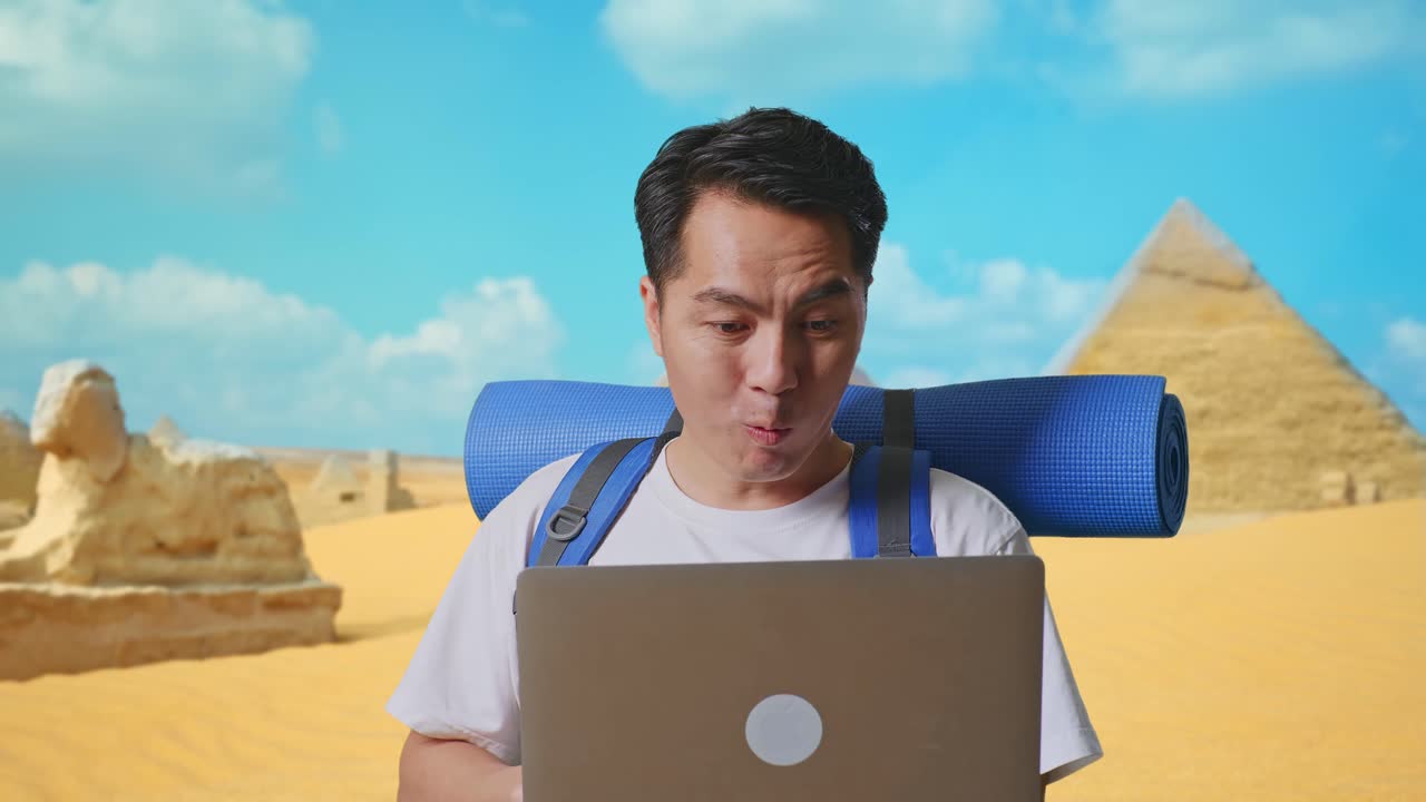 Excited Tourist Using Laptop near Pyramids