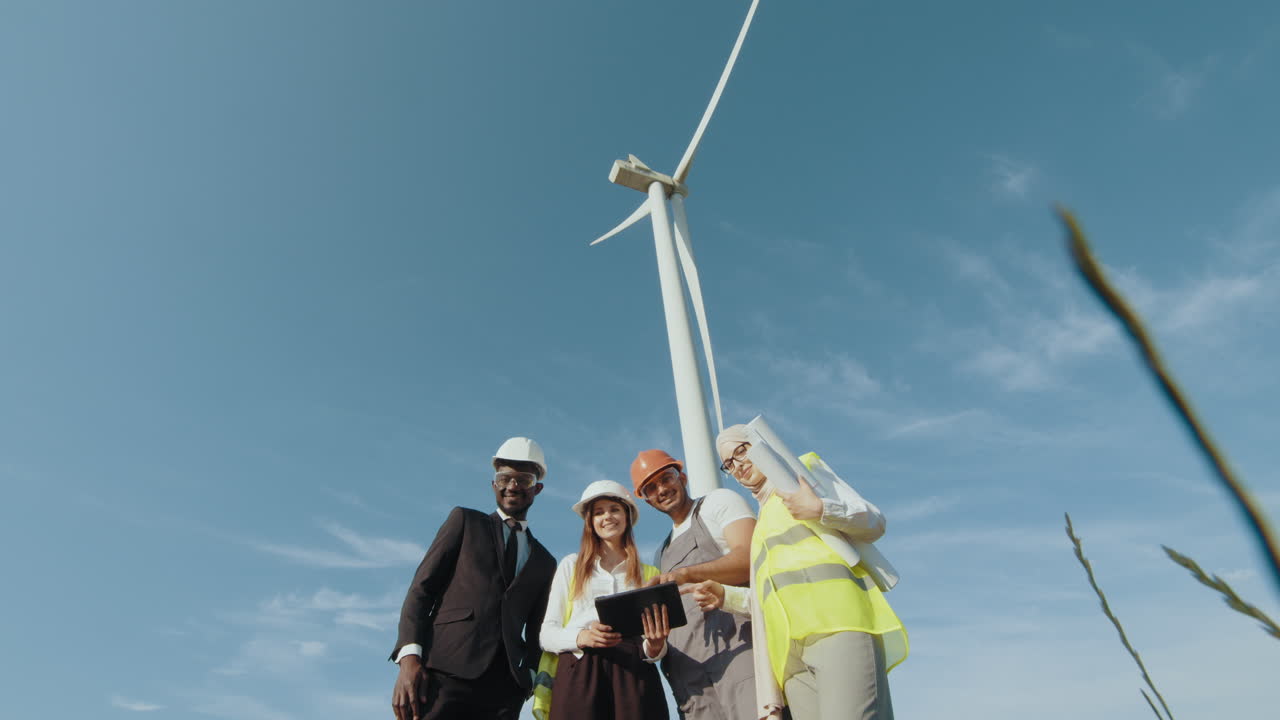 Team of Engineers Inspecting Wind Turbine