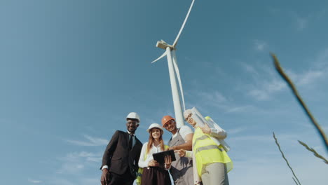 team of engineers inspecting wind turbine