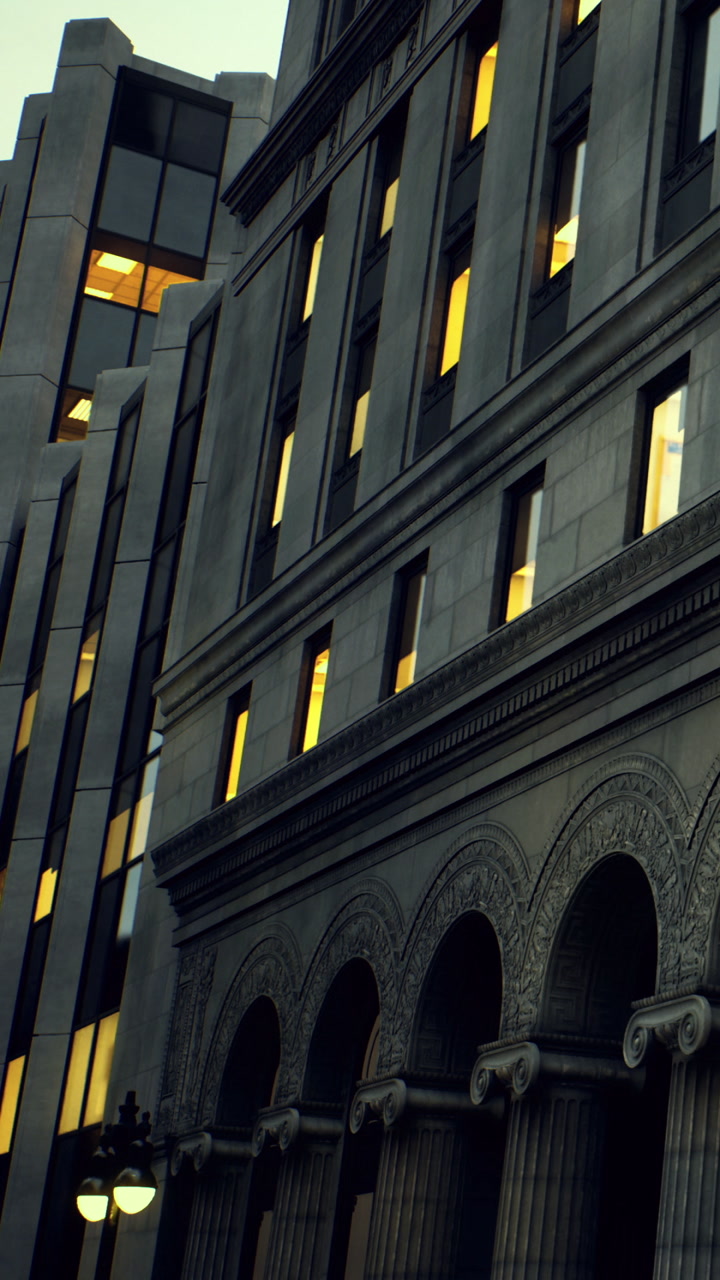 Buildings with lit windows at dusk in an urban setting in the city