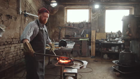 Blacksmith-Shaping-Wrought-Iron-Rod-in-Workshop