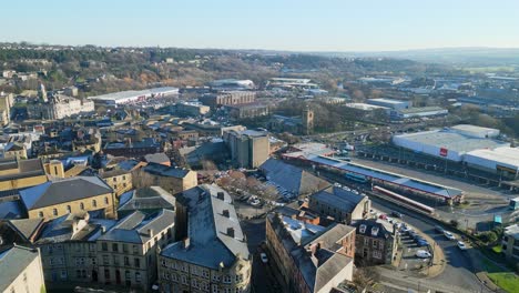 Cinematic-aerial-footage-of-a-small-industrial-town-in-Yorkshire-England-showing-church-industrial-areas,-and-busy-town-with-traffic-and-roads