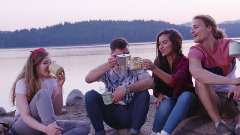 friends enjoying coffee by the lake at