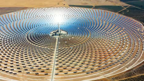 solar panels circular power plants with the reflection of the sunlight in the panels to produce renewable and pollution-free energy - aerial view with a drone - environmental concept