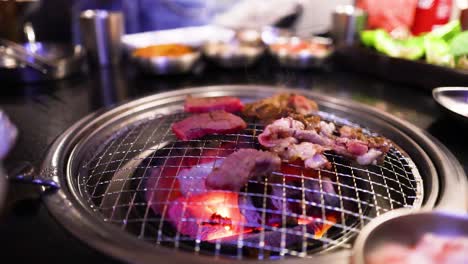 grilling meat on a korean bbq grill