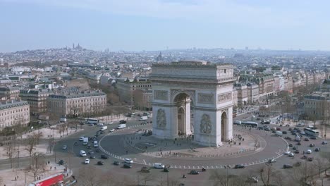 Cars-driving-around-Triumphal-arch-or-Arc-de-Triomphe-in-Paris-town-center,-France