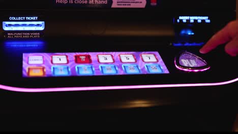 player engaging with an arcade touchscreen game