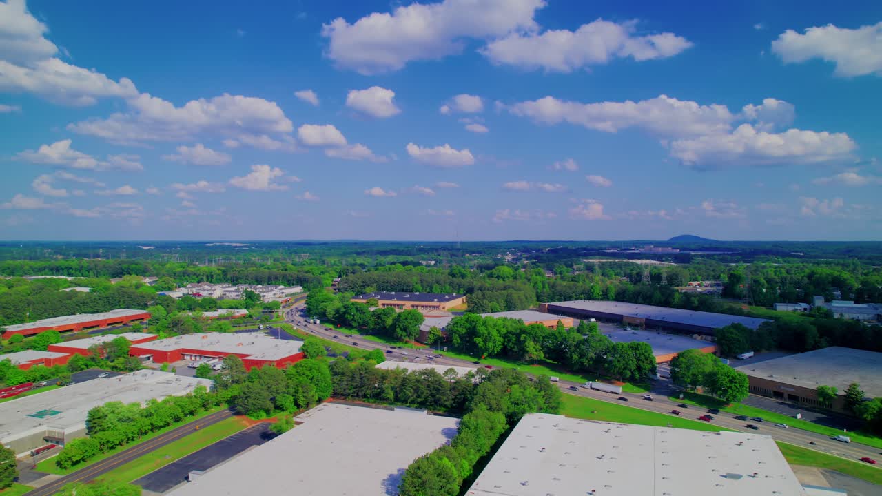 Aerial footage of industrial and business park in Norcross, Georgia, showcasing commercial buildings, warehouses.