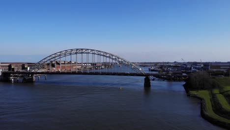 arch bridge over noord river with a view of hendrik-ido-ambacht town in south holland, netherlands