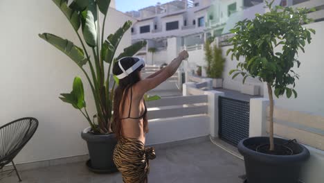 woman wearing vr headset and controllers in a tropical patio