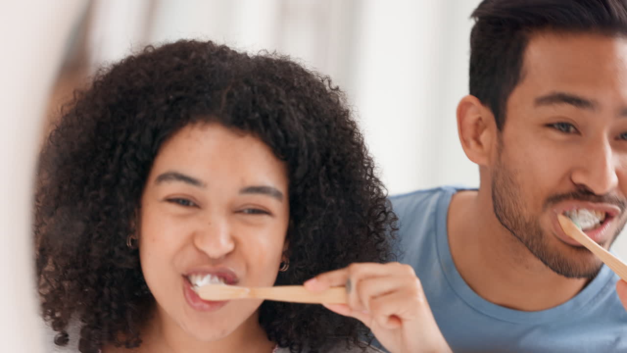 Love, mirror and couple in bathroom brushing teeth