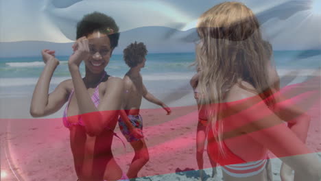 animation overlay of flag on young adults at beach during sunny day