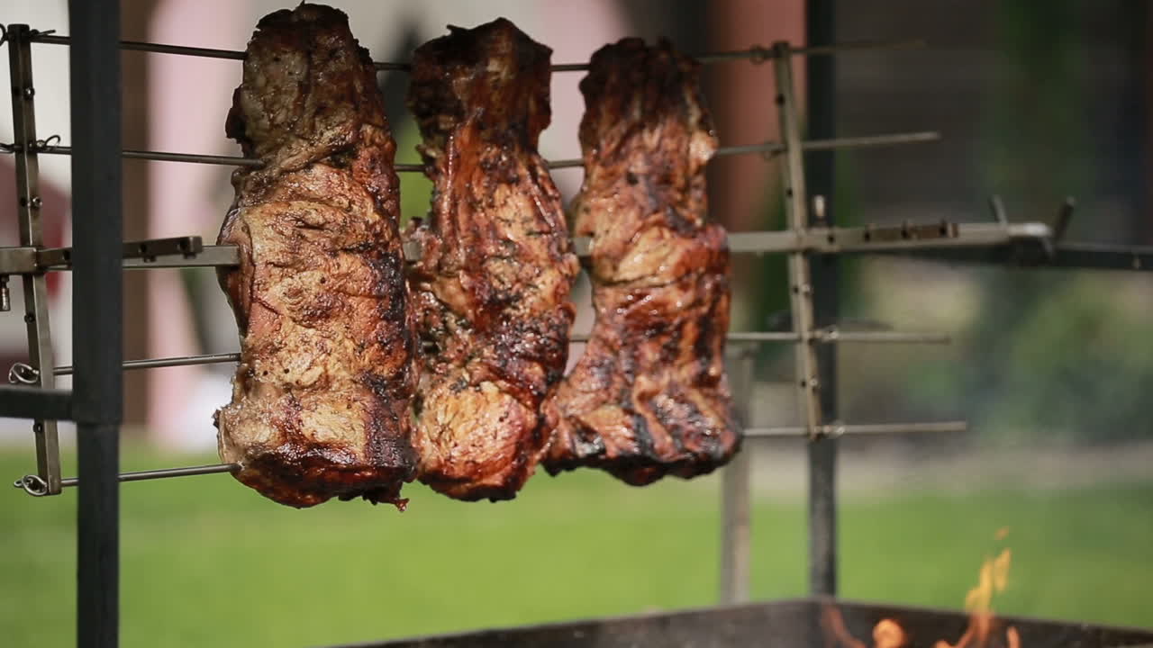 Beef steaks on the grill. Close up of the steak broiled on flame barbecue