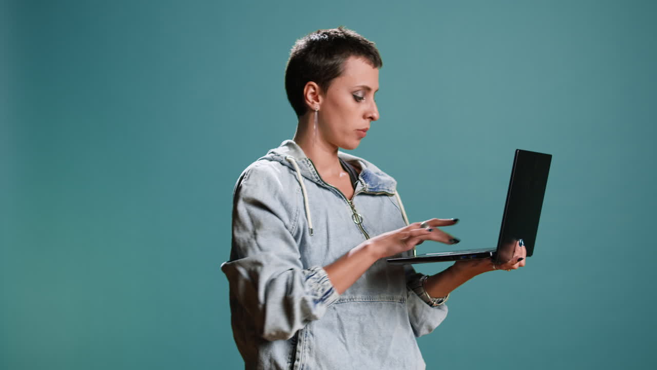 Woman using a laptop in a studio