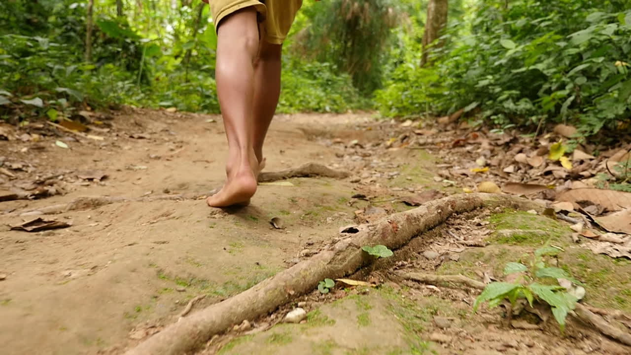 Child Walking Barefoot in a Jungle Path