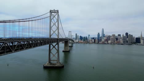 drone flies forward over oakland bay bridge toward san francisco skyline (60fps)