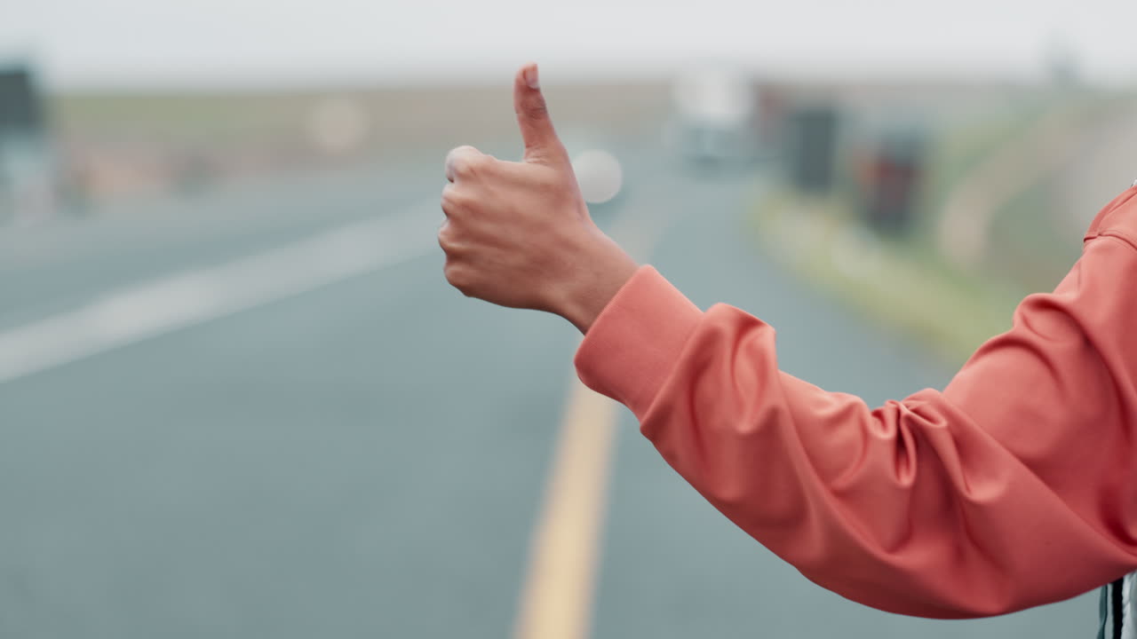 Thumb up on a foggy road