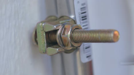 man checking a bolt after tightening it to confirm whether it will hold