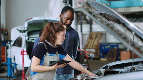 engineer informs man of car repair costs