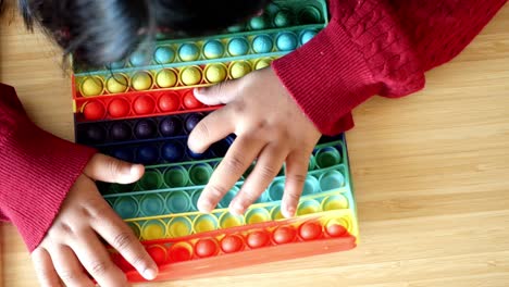 a child playing with a pop it toy