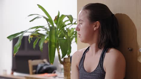 close up shot of teenage girl training arms with weights at home