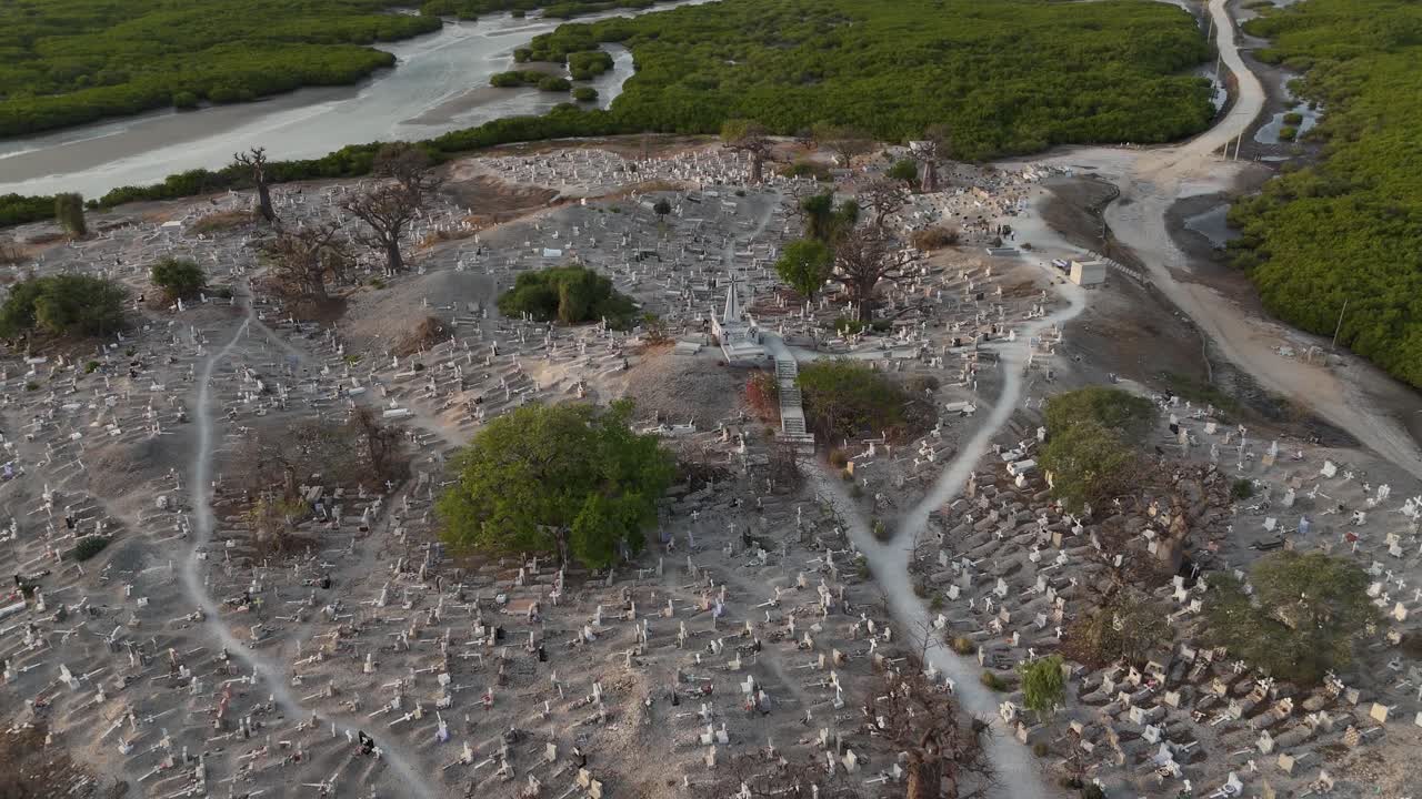 Drone aerial of Joal Fadiouth shell graveyard in Senegal, unique cemetery built on seashells, surrounded by water channels and village houses