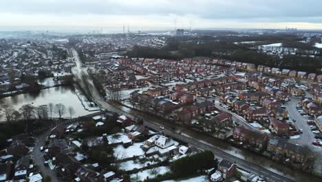 Snowy-aerial-village-residential-neighbourhood-Winter-frozen-North-West-houses-and-roads-high-pan-right-slow