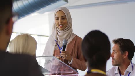 female speaker addressing the audience at a business conference