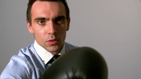 businessman punching with black gloves