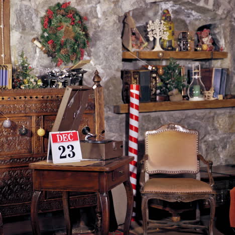 santa changes the calendar page into 24th of december. christmas decorated room and santa flipping the calendar on a wooden table.