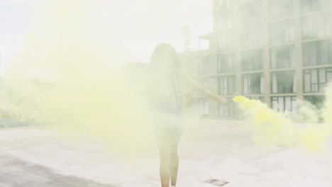 Fashionable-young-woman-on-urban-rooftop-using-smoke-grenades