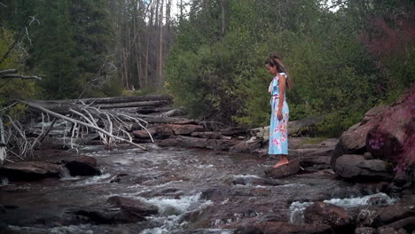 Cinematic-female-women-actress-model-walking-on-rocks-towards-still-calm-Piney-River-Ranch-Denver-Vail-Beaver-Creek-Avon-Gore-range-scenic-mountain-landscape-gold-hour-light-adventure