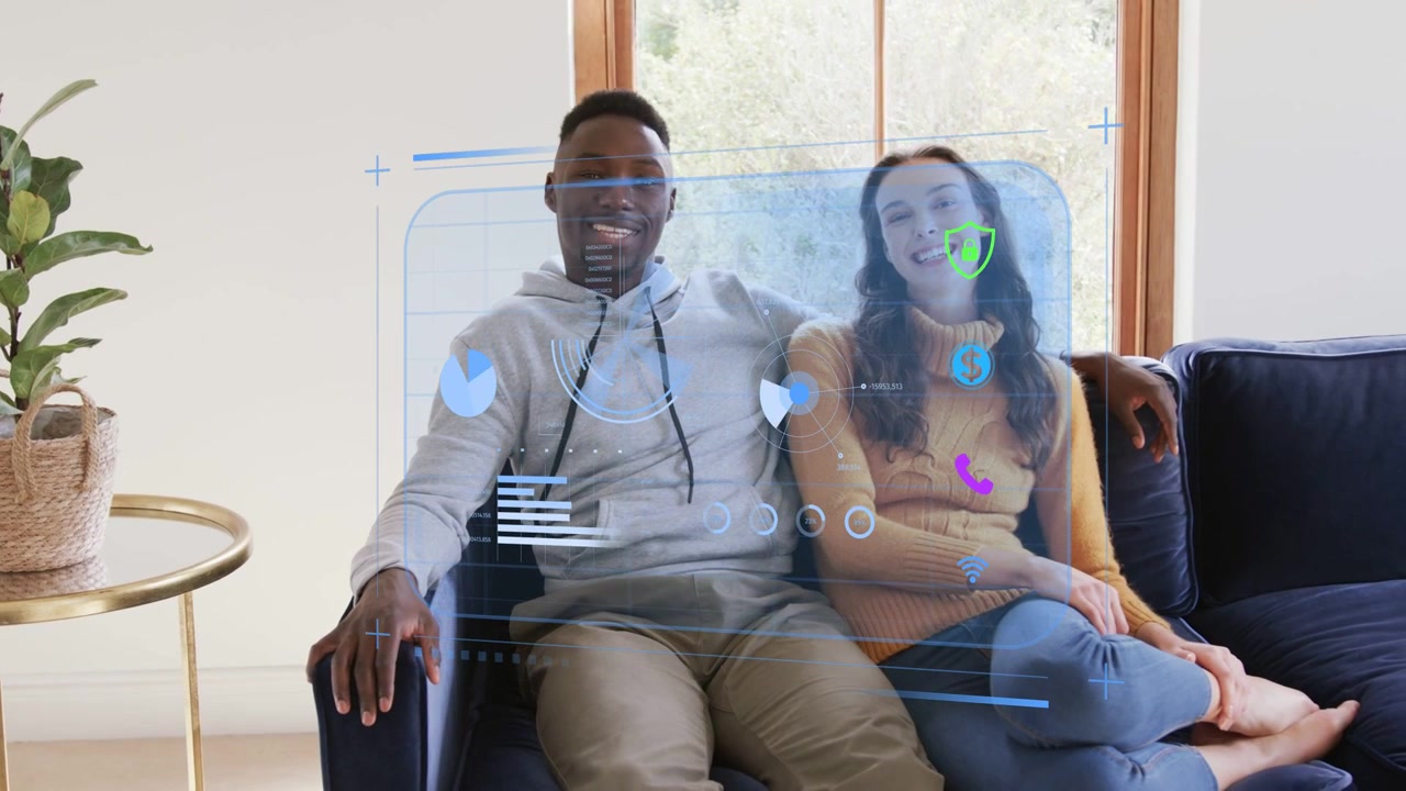 Couple sitting while holo finance UI appearing, charts updating, reviewing finances and smiling