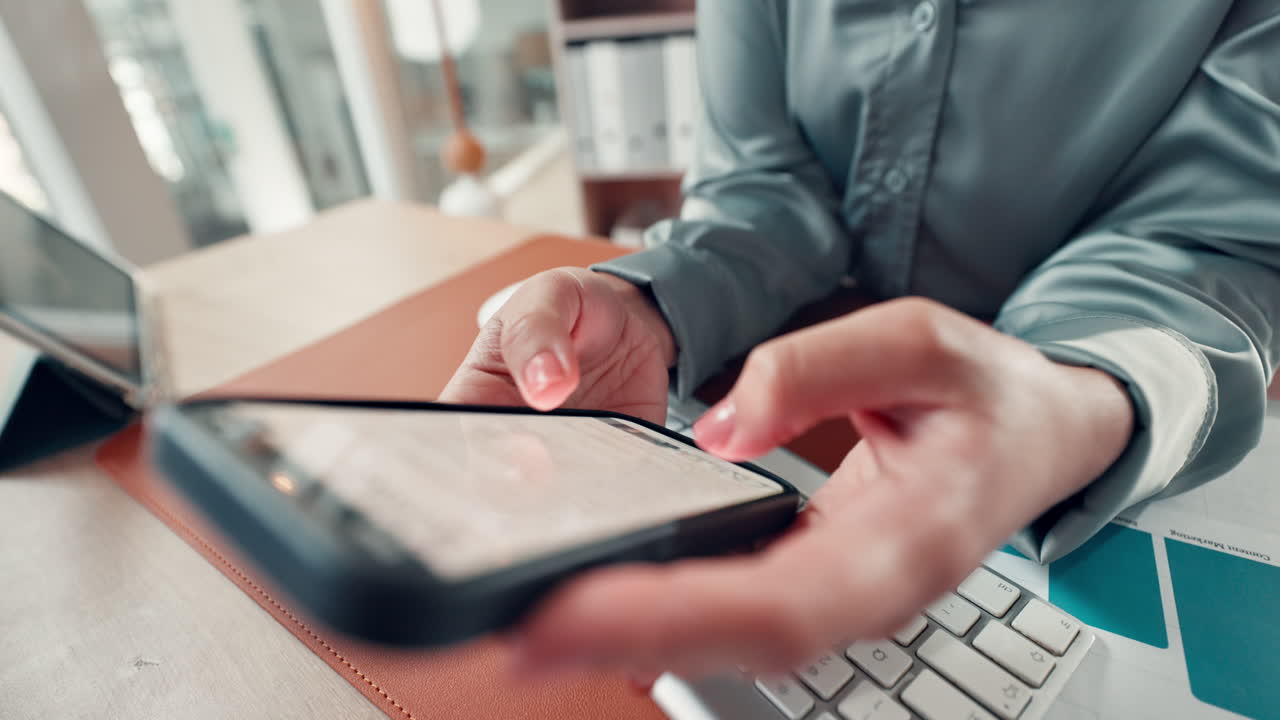 Woman using mobile phone at her desk