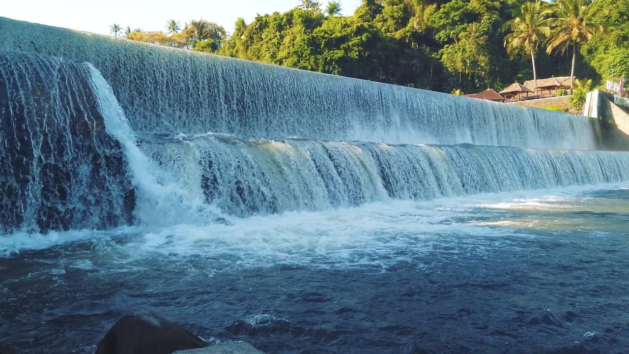 Waterfall, wet stream DAM at Klungkung Bali Indonesia, nature cascade, river falling, slow motion panoramic view