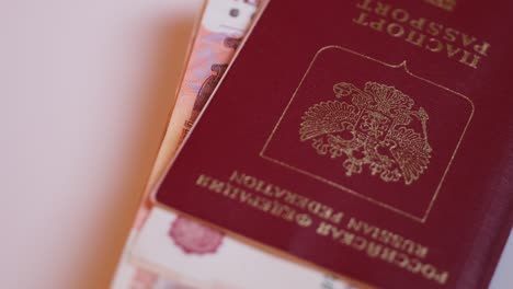 documents and russian money for a trip to other countries rotate in a circle on the platform.