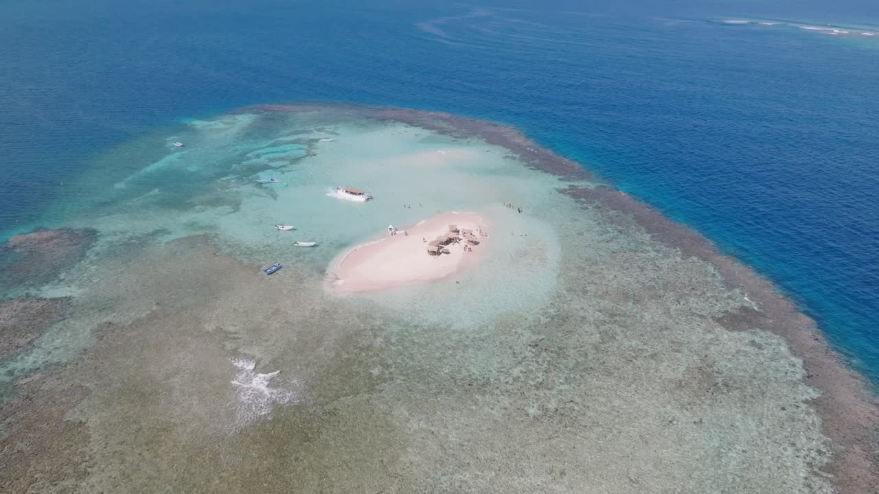 Aerial View of a Stunning Tropical Island with Turquoise Water and White Sand Beach