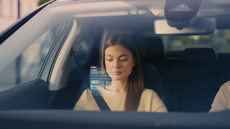 woman interacting with holographic display in a modern car