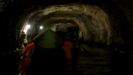 exploring a cave by boat in vietnam