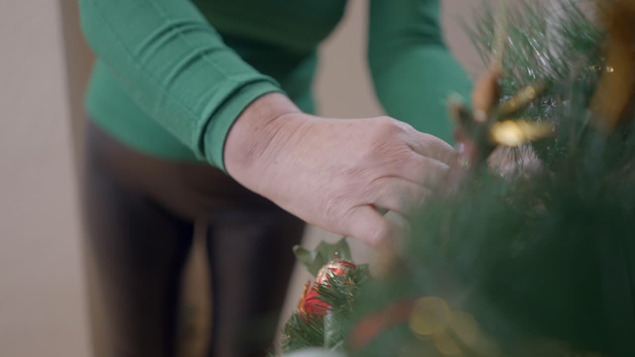 Elderly Woman Decorating Christmas Tree