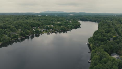 magog river with lush green vegetation in sherbrooke, canada - aerial shot