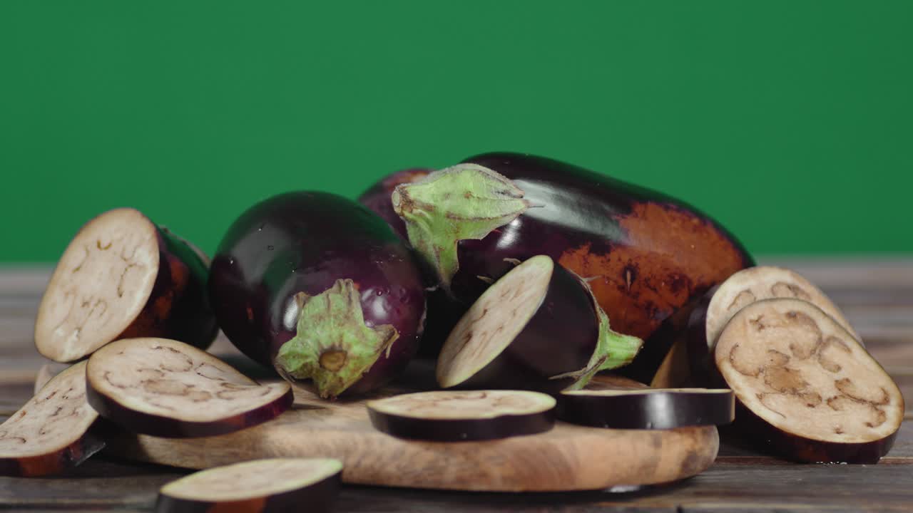 Slices of fresh eggplant on the cutting Board slowly rotate.