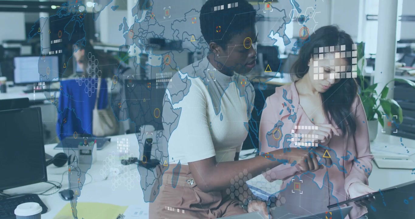 Women in tech pointing at tablet causing world map overlay fading in for data analytics