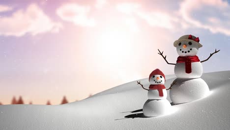 snow falling over snowwoman and baby snowman on winter landscape