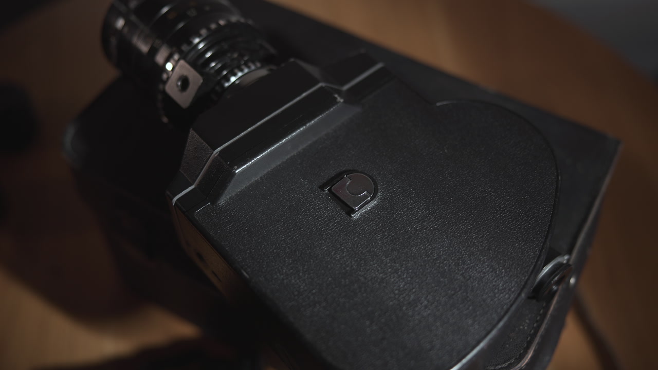 Rear Plate Closeup On Textured Camera Body, Panel Details And Mount Visible, Finger Pressing Latch . Media