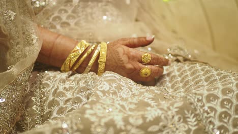 woman's hand with wedding jewelry and mehndi