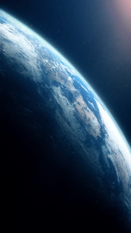 vertical format : a cinematic rendering of planet earth during sunrise as view from space with vibrant blue sky atmosphere